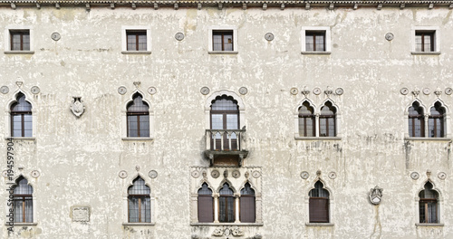 Main facade of the Palazzetto Veziano (Venetian palace), old historical building in Udine, Italy. Traditional Italian architecture