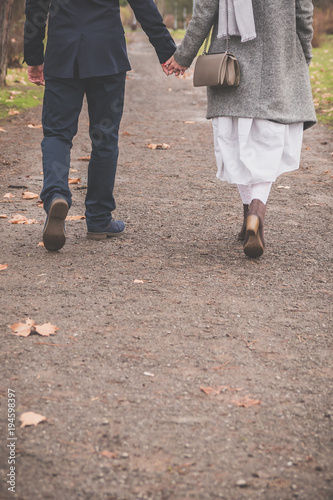 Couple in love walking and holding hands copy space