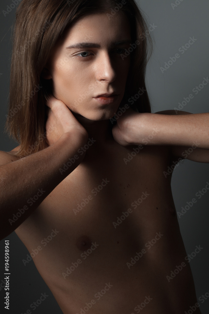 Feminine young man. Portrait on a black background. Close up Feminine young man. Portrait on a black background. Close up
