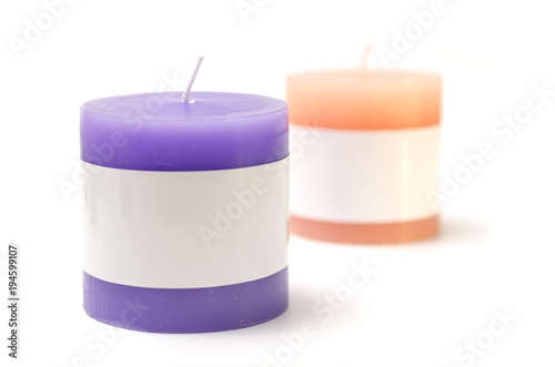 two candles pink and purple isolated on white background