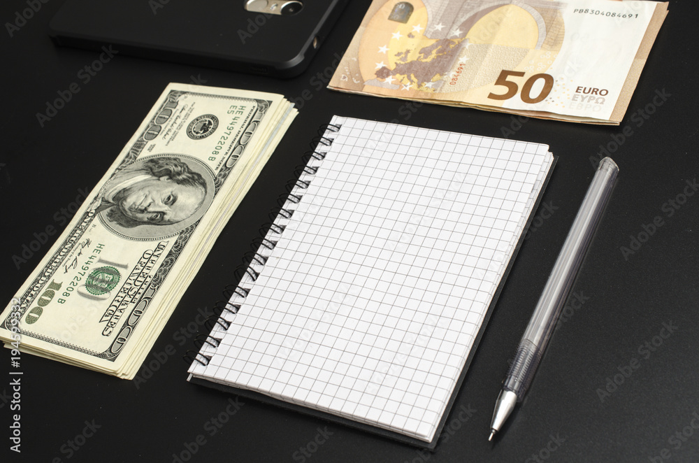 unwritten notepad, pen, money and cellphone unwritten notepad, pen, money and cellphone