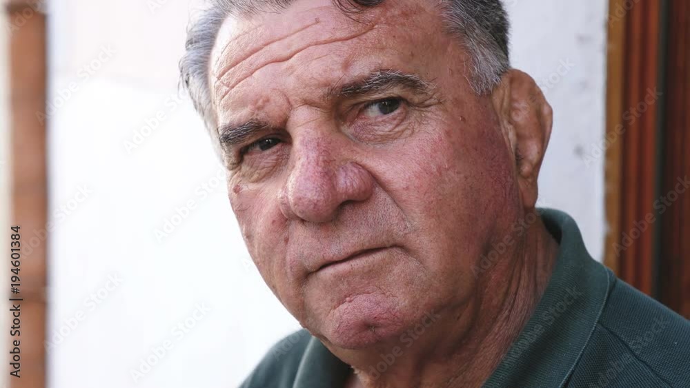 close up on pensive old man looking at camera close up on pensive old man looking at camera
