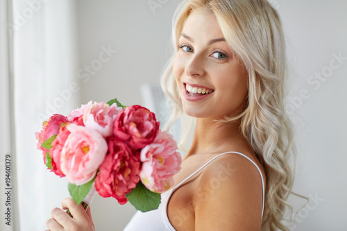 close up of woman with bunch of flowers