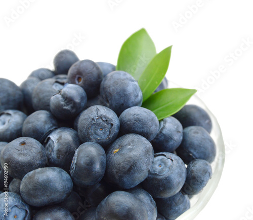 Blueberries in glass bowl on white background
