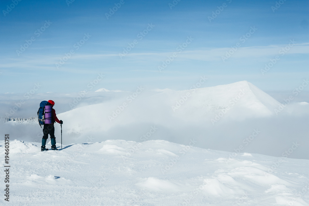 Climber admiring scenic view of snowy Gorgany mountains