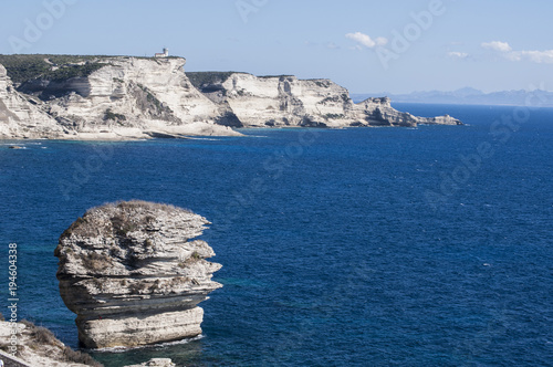 Corsica, 05/09/2017: le bianche scogliere di Bonifacio nella riserva naturale del Parco internazionale delle Bocche di Bonifacio, con vista del faro di Capo Pertusato photo