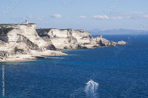 Corsica, 05/09/2017: le bianche scogliere di Bonifacio nella riserva naturale del Parco internazionale delle Bocche di Bonifacio, con vista del faro di Capo Pertusato photo