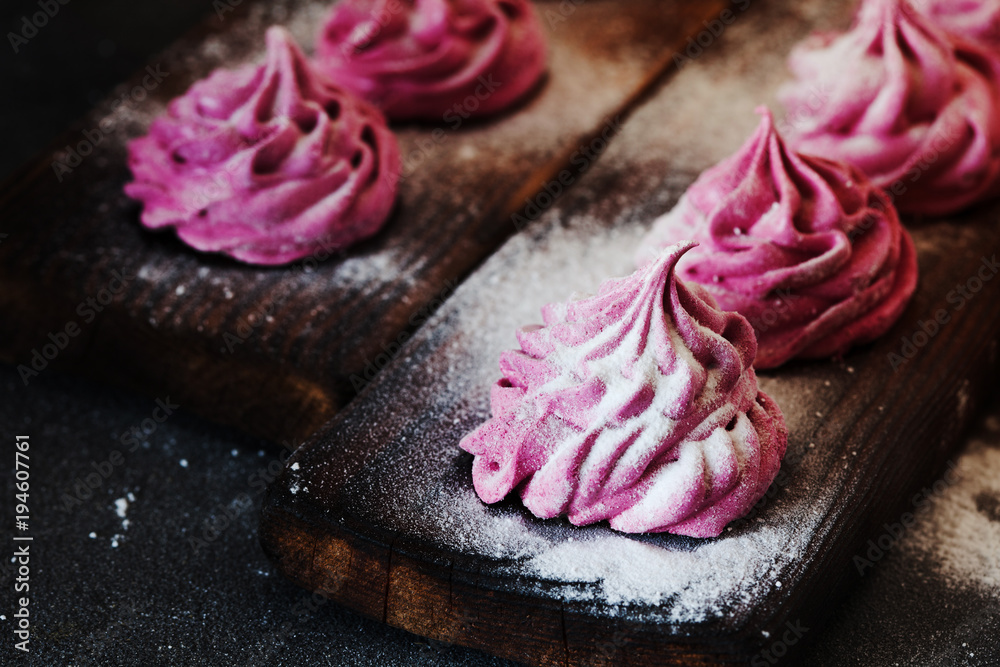 Pink homemade zephyr or marshmallow on dark background Pink homemade zephyr or marshmallow on dark background