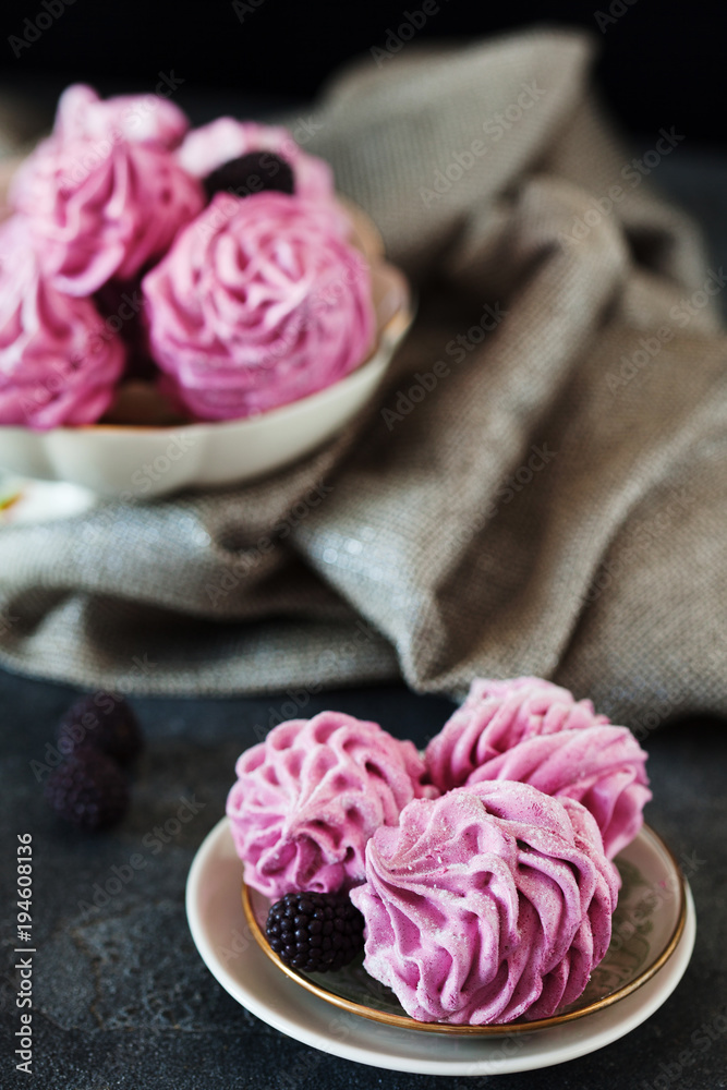 Pink homemade zephyr or marshmallow on dark background Pink homemade zephyr or marshmallow on dark background