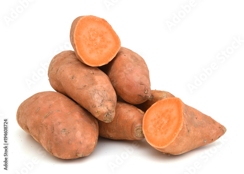 whole and halved sweet potatoes isolated on white