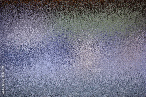 Frosted glass texture. Colorful lights background.