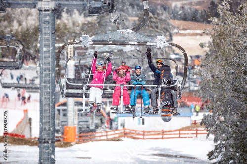 People are lifting on ski-lift in the mountains