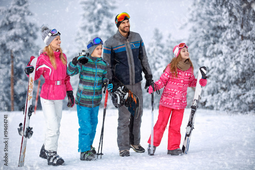 Skiing, winter, snow and fun - family enjoying winter vacations