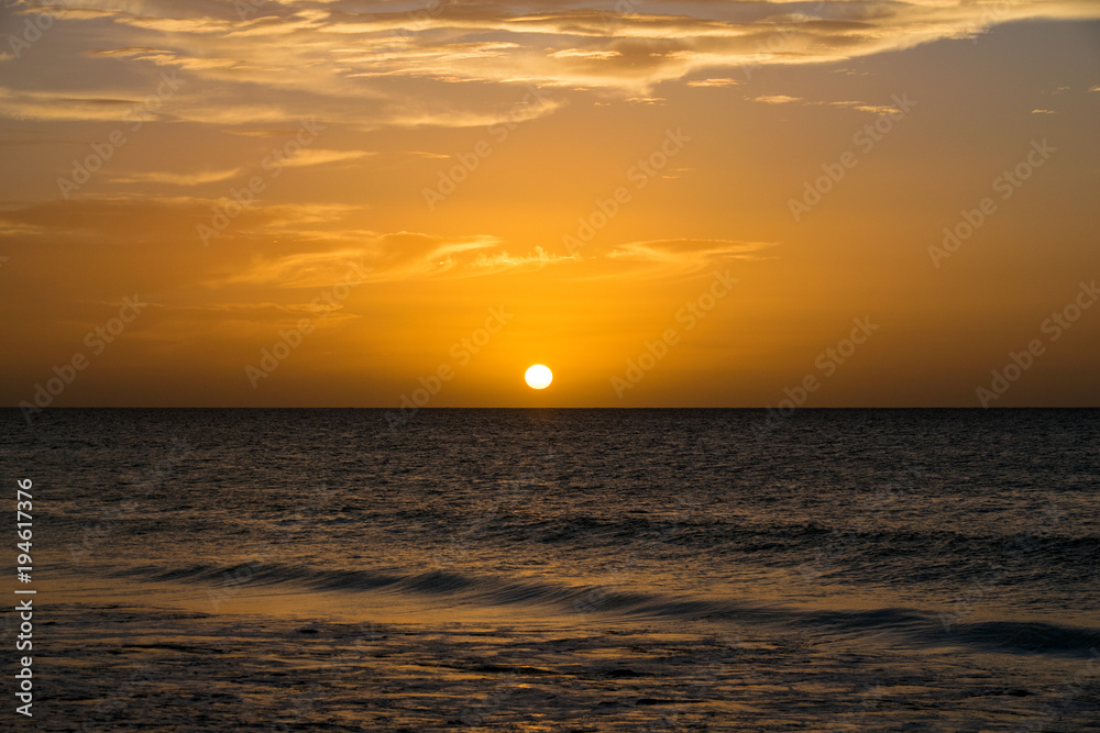 Golden sunset over a calm still ocean sea, Boa Vista, Cape Verde Islands