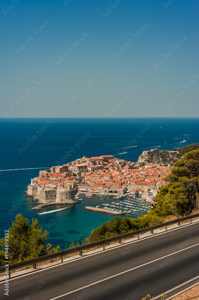 Spectacular picturesque view on the old town (medieval Ragusa) and Dalmatian Coast of Adriatic Sea. Picture taken from the mountain trails above Dubrovnik citadel, Famous European Travel Destination.