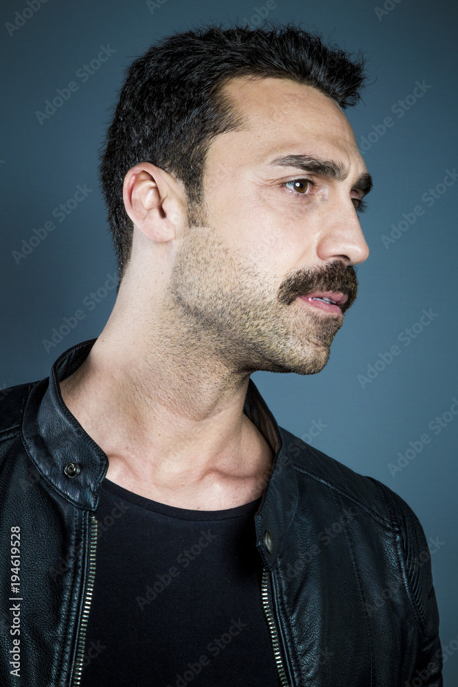Fototapeta premium Young handsome man with beard and mustache studio portrait