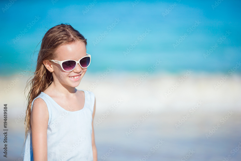 Beautiful little girl in sunglasses at beach having fun. Funny girl enjoy summer vacation. Beautiful little girl in sunglasses at beach having fun. Funny girl enjoy summer vacation.