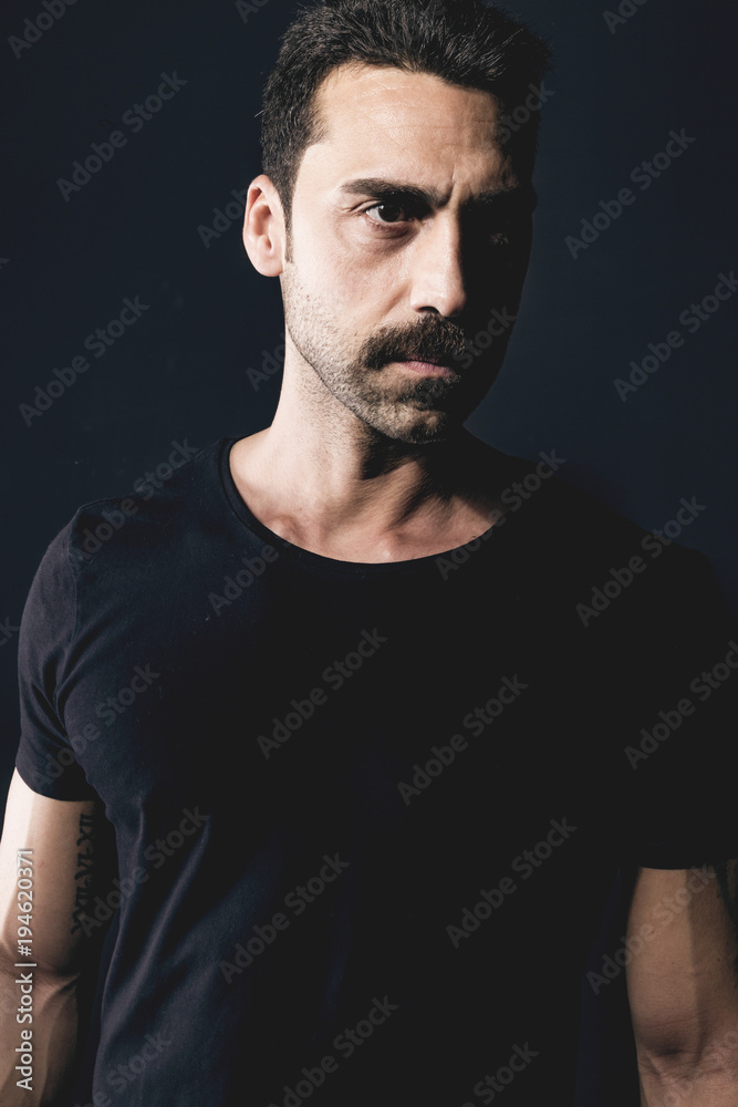 Young handsome man with beard and mustache studio portrait