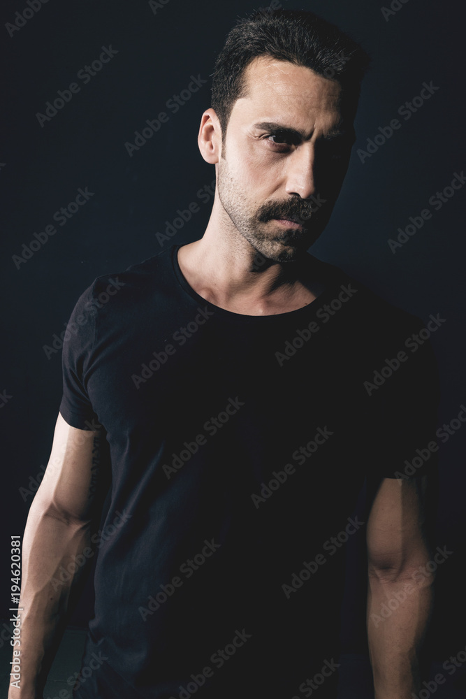 Young handsome man with beard and mustache studio portrait