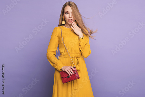 Fashionable woman in nice yellow dress, handbag and accessories. Fashion spring summer photo