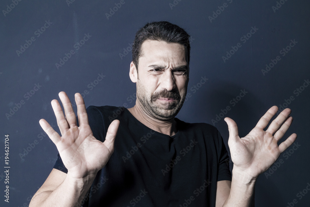 Man with moustache showing a disgusted facial expression Man with moustache showing a disgusted facial expression
