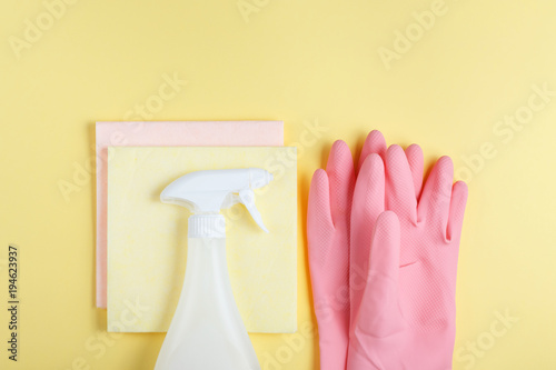 flat laying, tools for harvesting on a yellow background, swipe to dust, pink gloves, sprayer