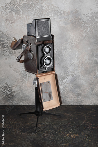 The old medium-format TLR camera on cement wall background. photo
