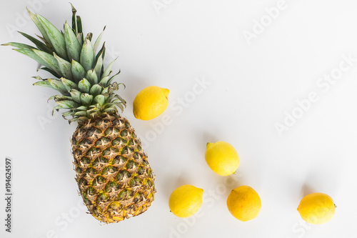 pinneapple and lemons on white background photo