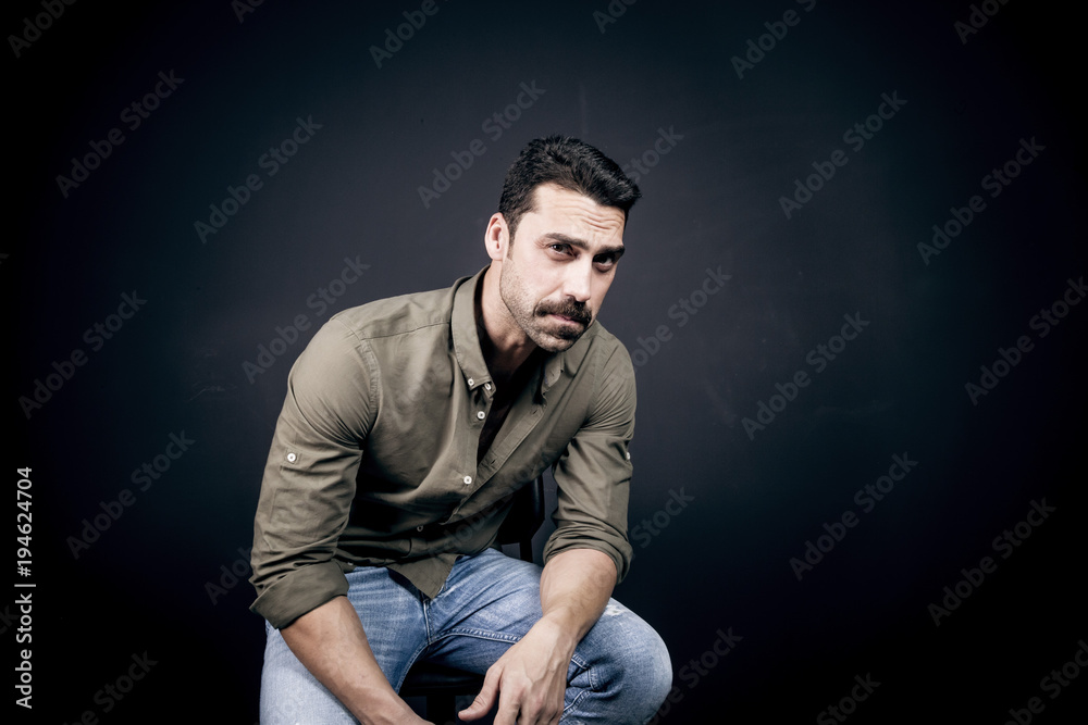 Young handsome man with beard and mustache studio portrait