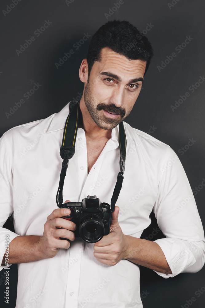 Young handsome photographer with beard and mustache studio portrait Young handsome photographer with beard and mustache studio portrait