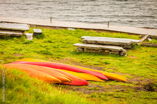 Many canoes on norwegian fjord shore photo