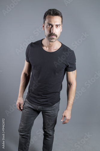 Young handsome man with beard and mustache studio portrait