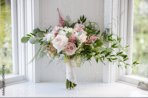 Pink and White Floral Wedding Bouquet with Roses and a Handkerchief in Window photo