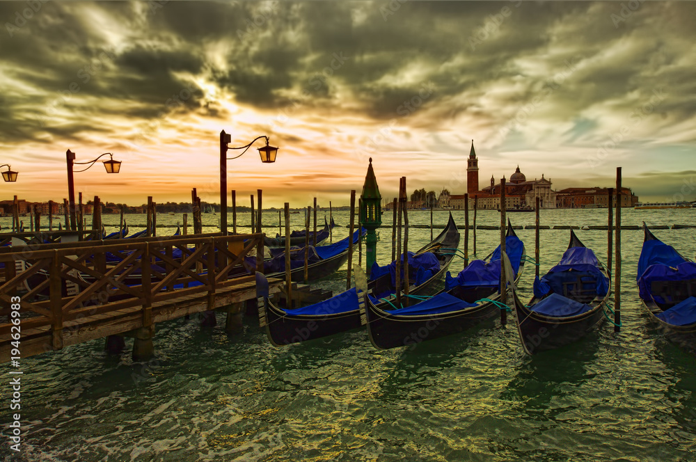 dramatic view of Venice city gondola at sunset