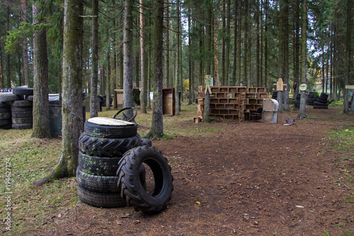 Tyres on paintball field in forest