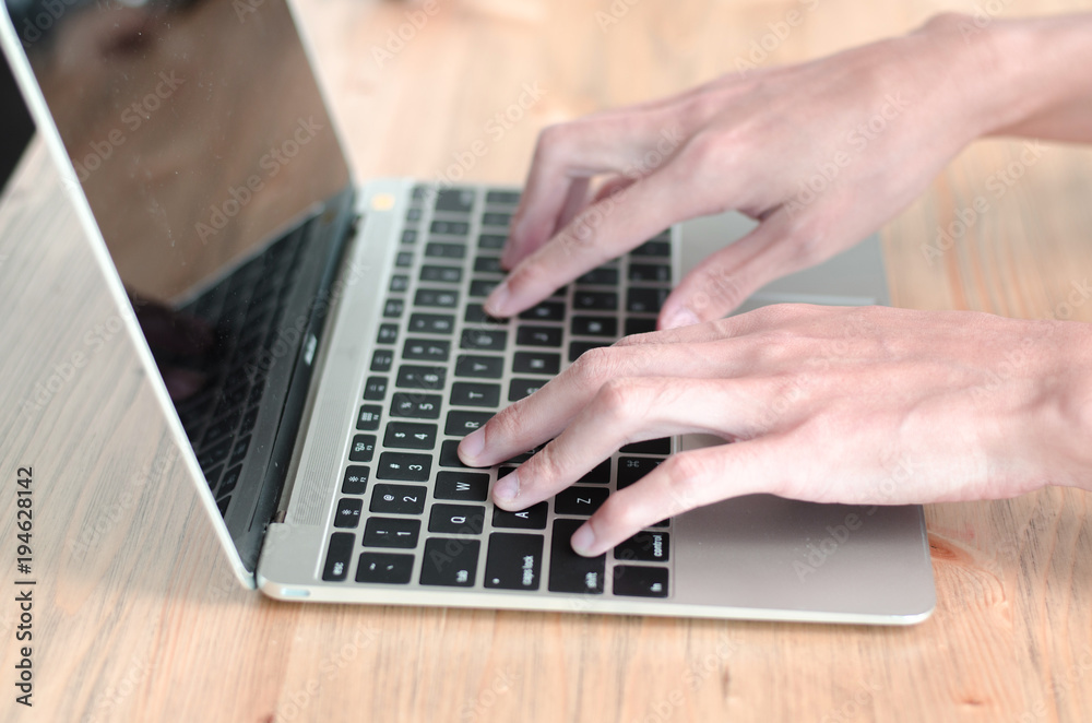 Female hand holding keyboard while working on computer Female hand holding keyboard while working on computer