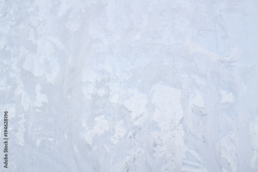 Fototapeta premium Winter frosty patterns on the frozen ice window