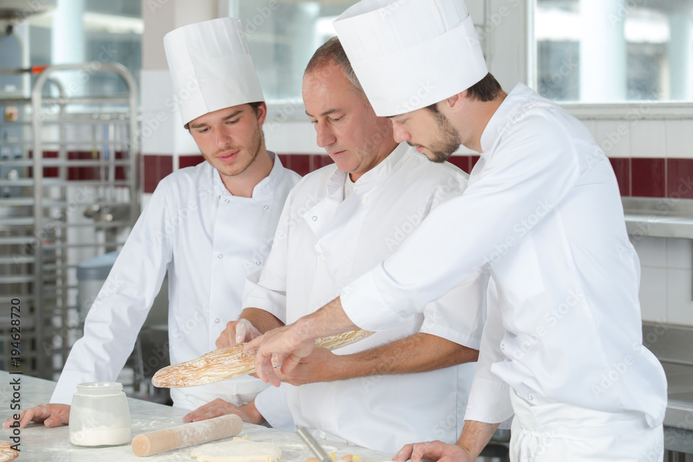 apprentice in bakery learning with professor