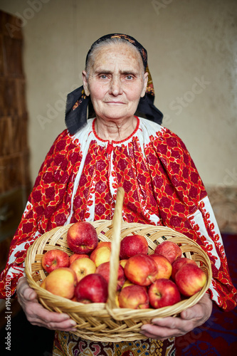 Farmer woman with a basket of apples