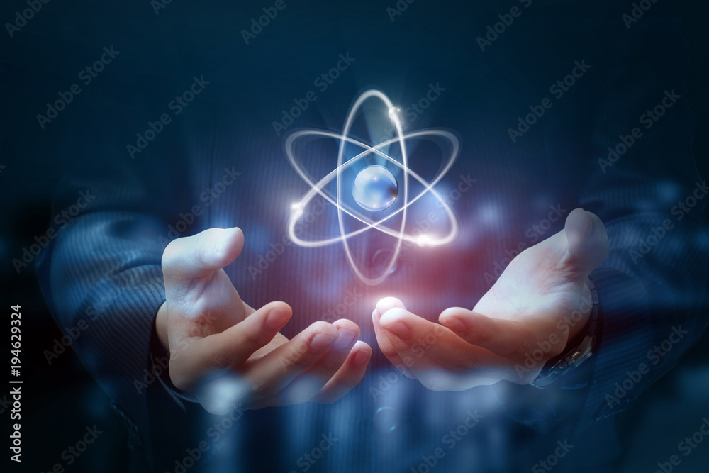 Hands shows the atom . - obrazy, fototapety, plakaty 