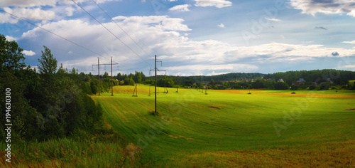 Panoramic rural landscape. Field of green grass and sky with clouds. Panorama shot. © Veresovich
