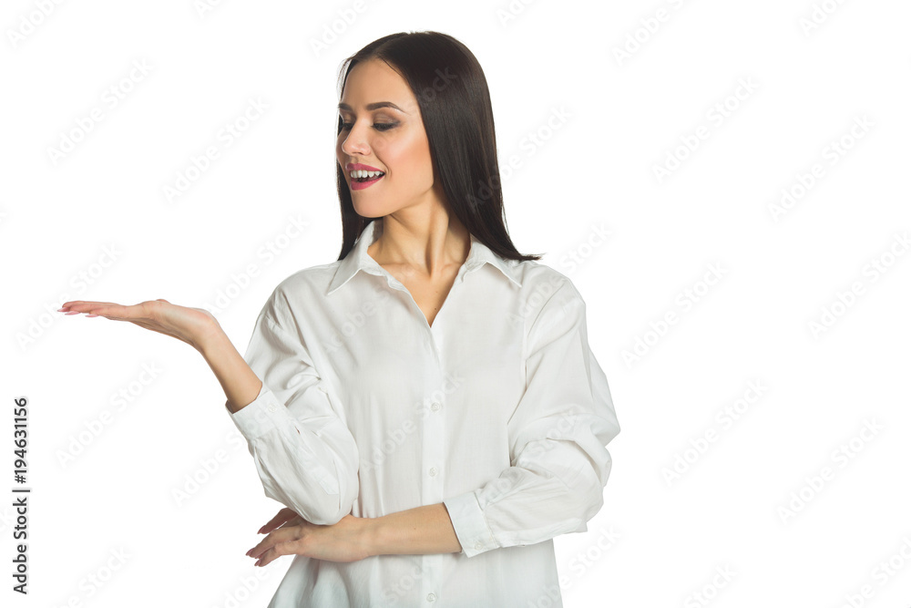beautiful young joyful girl with a smile in a white shirt on a white background advertising something beautiful young joyful girl with a smile in a white shirt on a white background advertising something