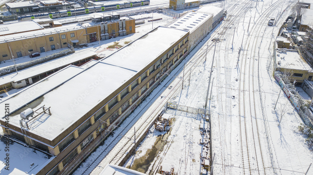 Aerial view of railroad section covered by snow. The tracks and rails are submerged by snow falling in Rome during the cold winter. The movement of metropolitan trains is blocked.