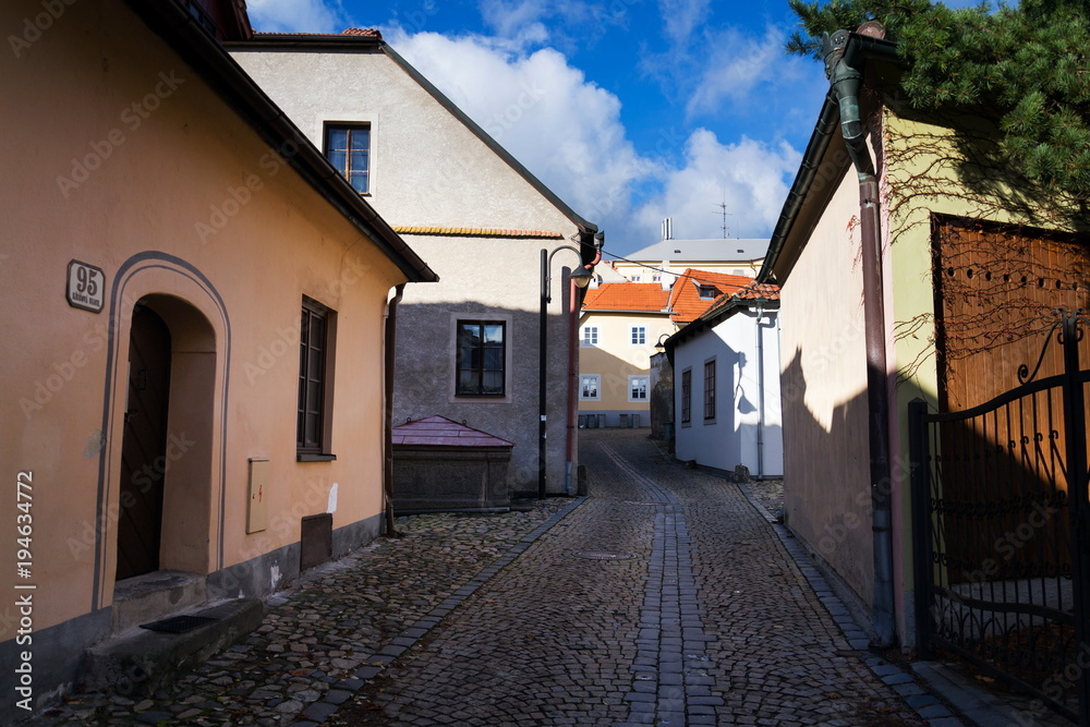 Covered old stone fountain on beautiful cobbled street of historic town Tabor, South Bohemia, Czech Republic, sunny day
