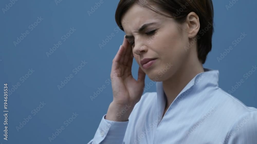 Sad woman with headache touching her temples Sad woman with headache touching her temples