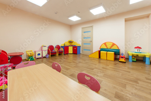 Spacious light pink colored game room with in the kindergarten