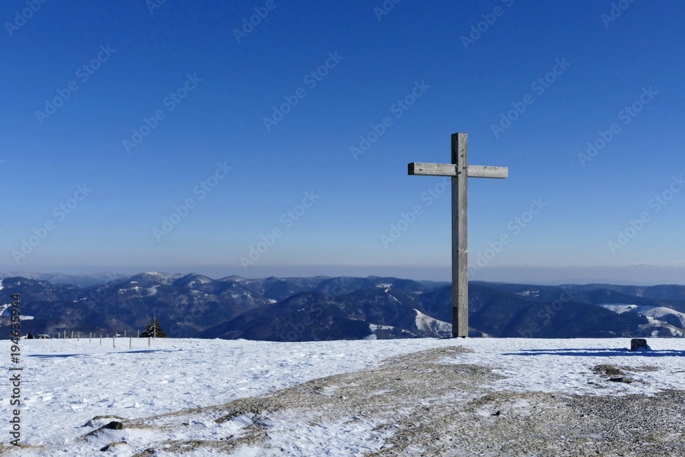 Summit cross on top of a mountain in the black forest Summit cross on top of a mountain in the black forest