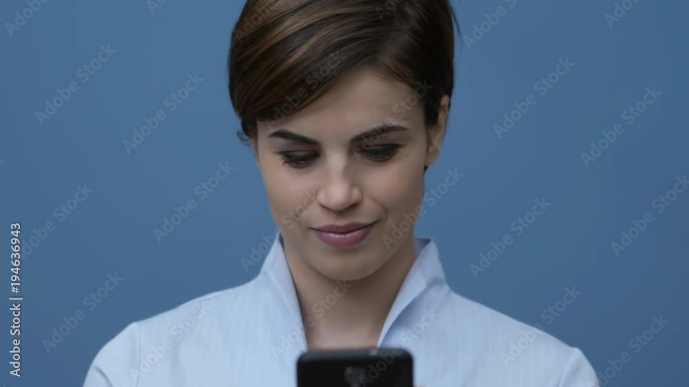 Pretty woman connecting with her smartphone Pretty woman connecting with her smartphone