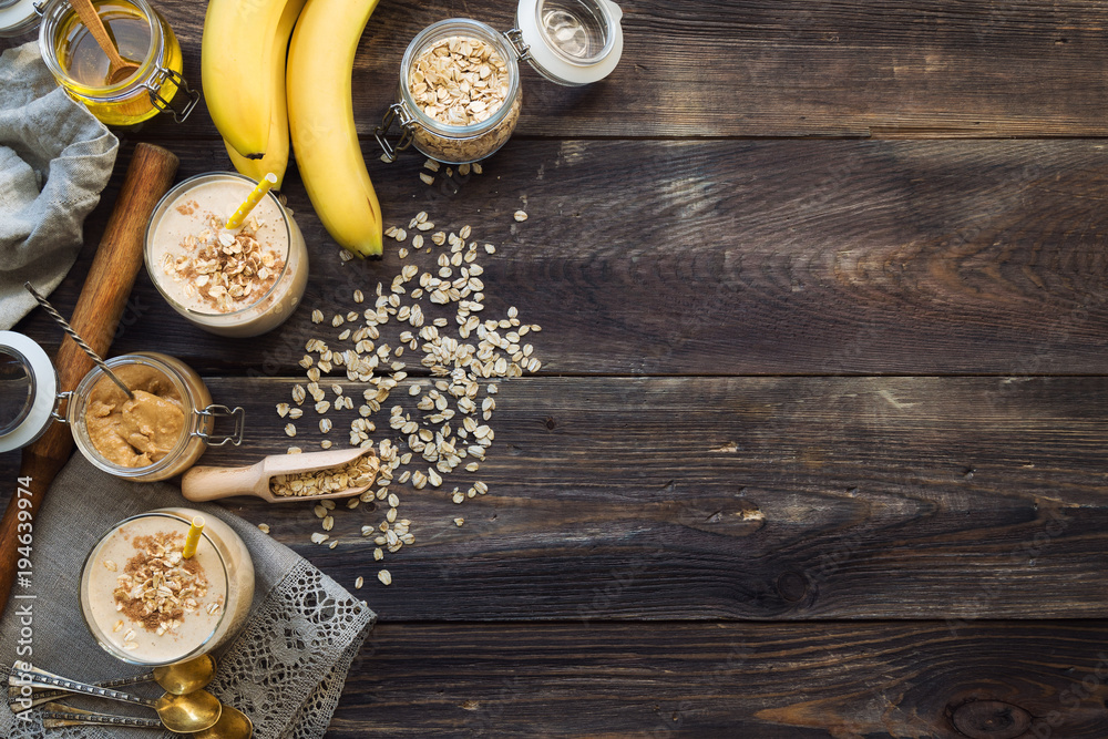 Nutritional smoothie with banana, oat flakes and peanut butter - obrazy, fototapety, plakaty 