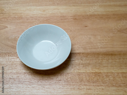 Angled shot of porcelain bowl with on chopping block